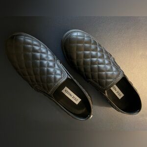 Steve Madden black leather quilted slip on tennis shoes.